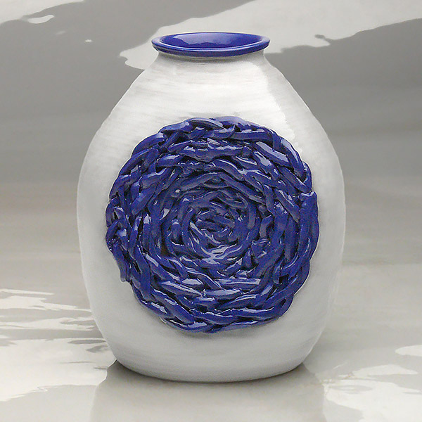 14-854. Nest Vase. 4 sided squat vase with braided nest.